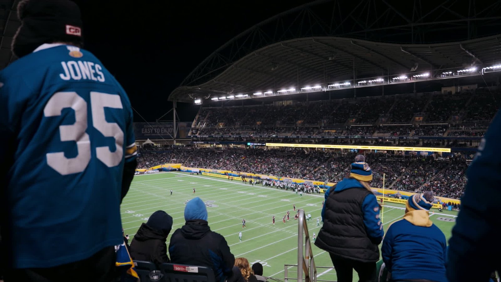 Fans overlooking a packed stadium at a live sporting event.